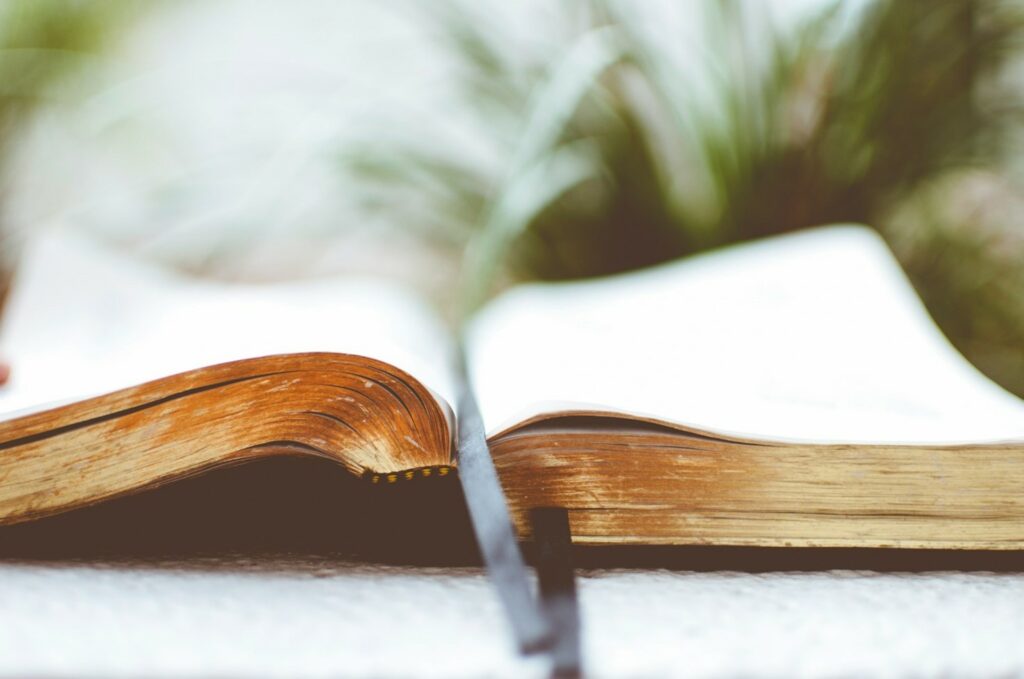 An open book with a ribbon bookmark resting in it