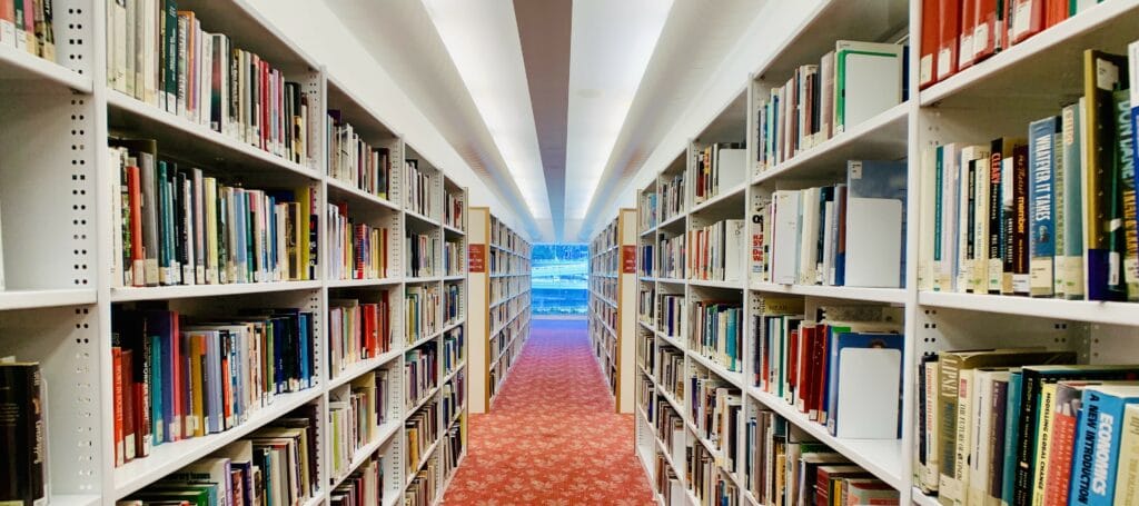 Two rows of full library bookshelves
