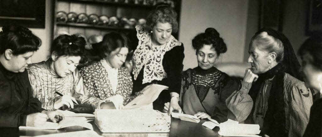 A black and white image of a Womens Social and Political Union Party meeting taken around 1906