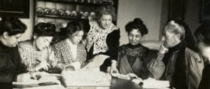 A black and white image of a Womens Social and Political Union Party meeting taken around 1906